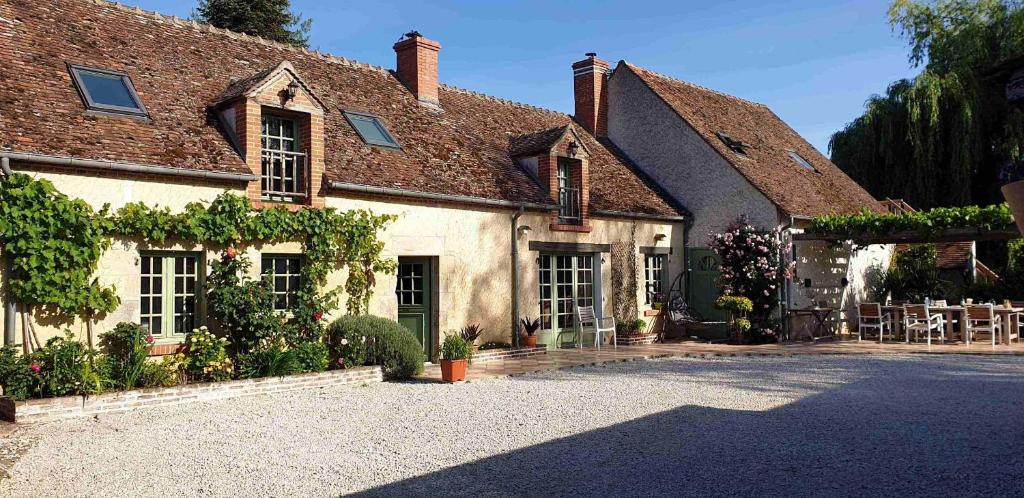 una casa antigua con un patio frente a ella en Chambres et Table d'hôtes Cerviña en Châteauneuf-sur-Loire