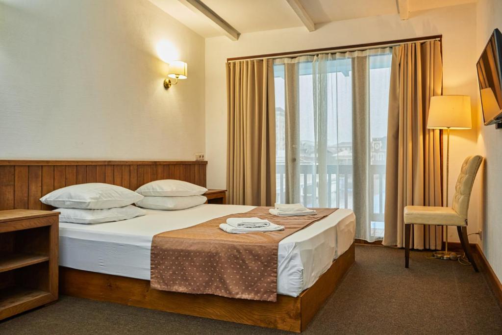 Postel nebo postele na pokoji v ubytování DEM Hotel