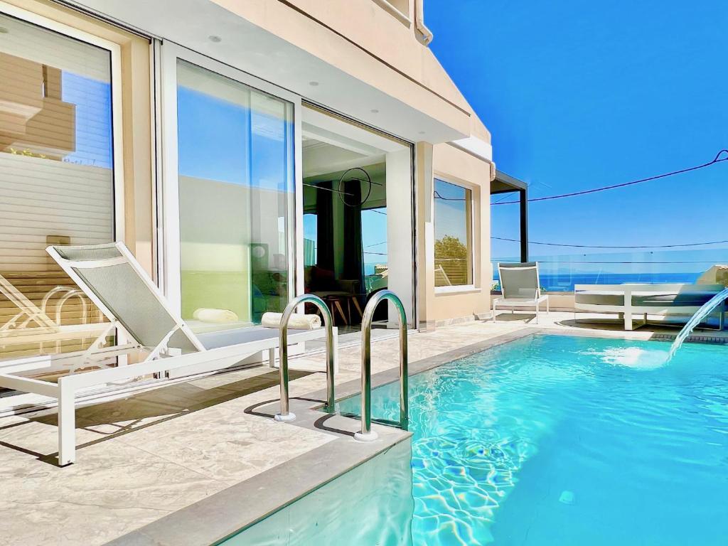 a villa with a swimming pool and a house at Luxury Villa Barbati Sun with private pool by DadoVillas in Barbati