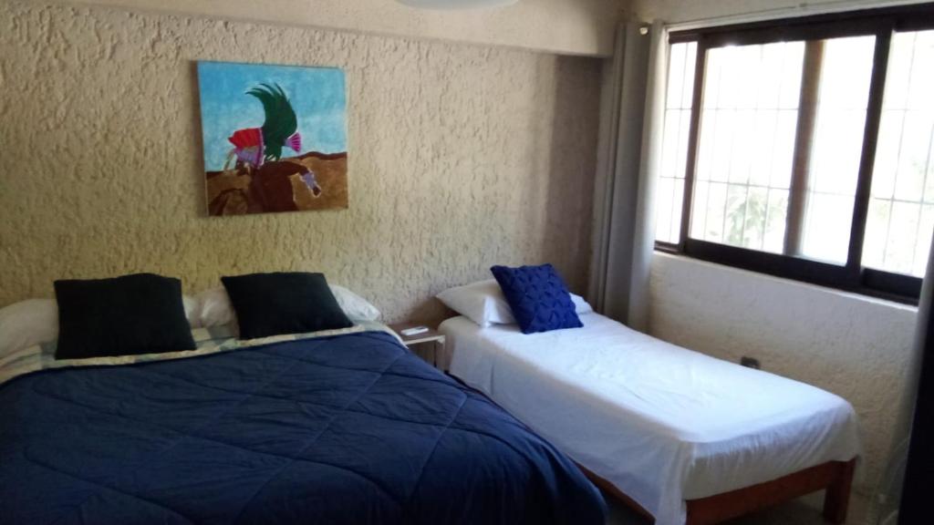 Postel nebo postele na pokoji v ubytování Naranjo Hostel