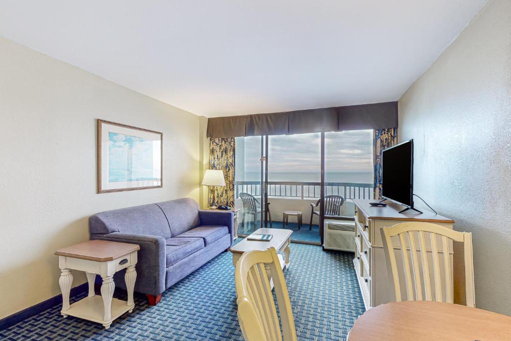 a living room with a couch and a tv at Compass Cove 655 in Myrtle Beach