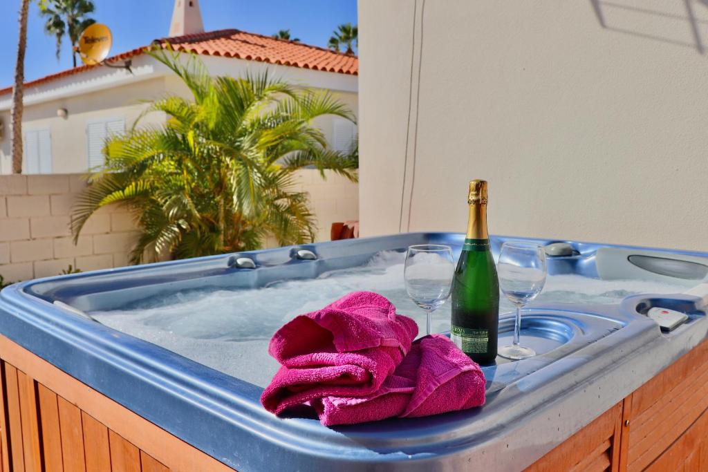 a bath tub with a bottle of champagne and a towel at Villa Julia Relax Dream Holiday in Callao Salvaje
