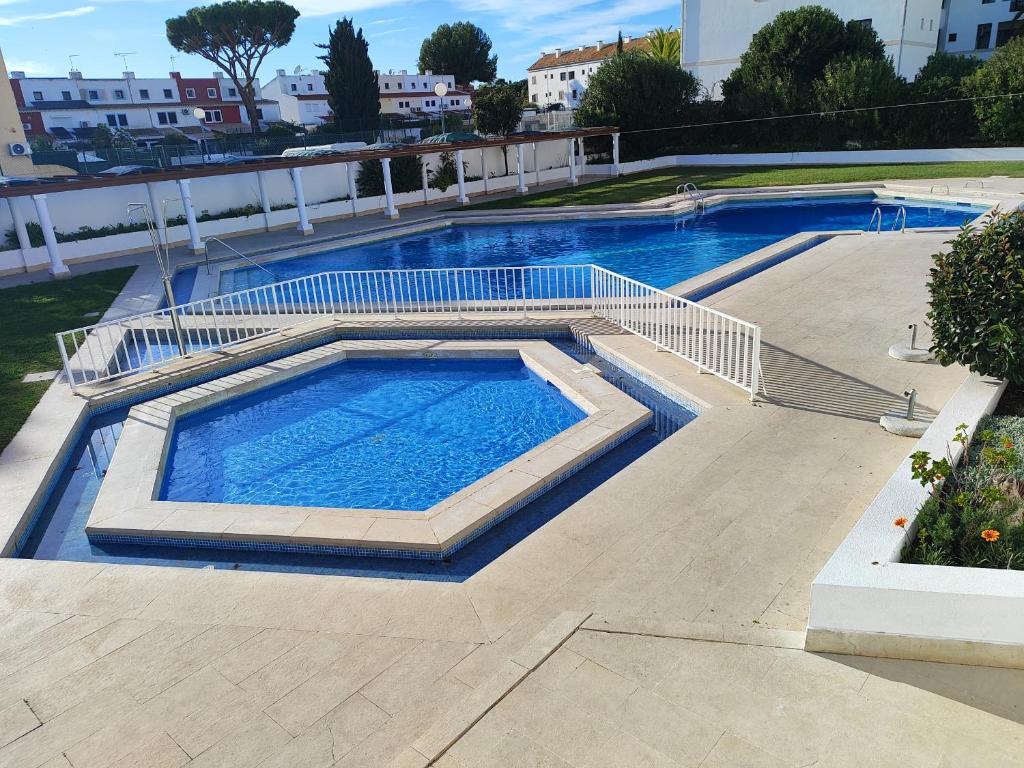 a large swimming pool on top of a building at Vilamoura Central 7 With Pool by Homing in Vilamoura