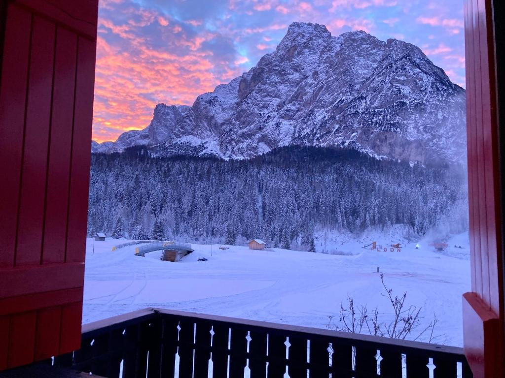 a view of a snow covered mountain from a window at Casa Isotta Sappada in Sappada