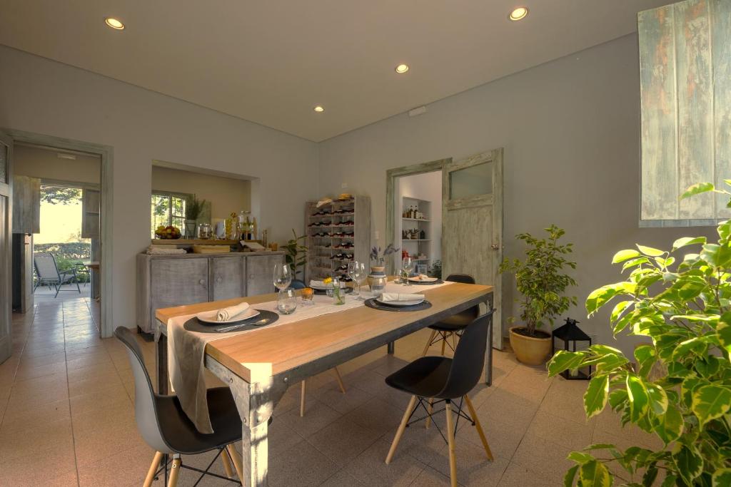 a dining room with a large wooden table and chairs at Boutique Vineyard and Wine Lodge in Maipú