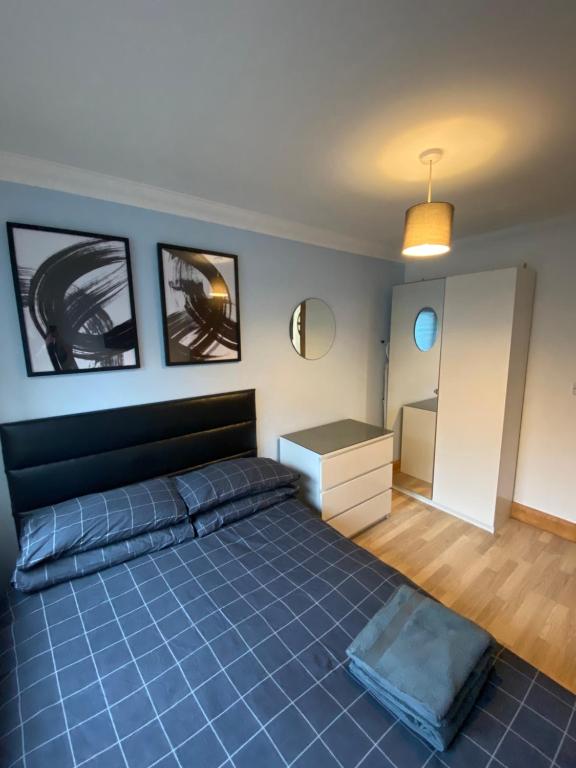 a bedroom with a large blue bed and a desk at Stylish 1 bedroom apartment in Norwich city centre in Norwich