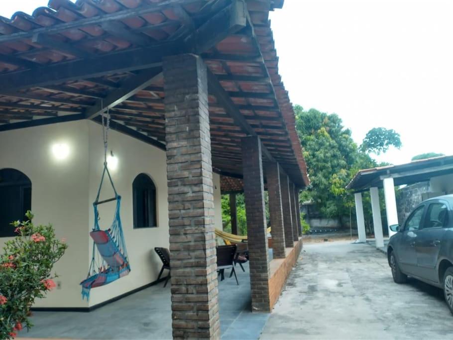 a patio of a house with a pergola at Casa de Praia em Itaparica in Itaparica