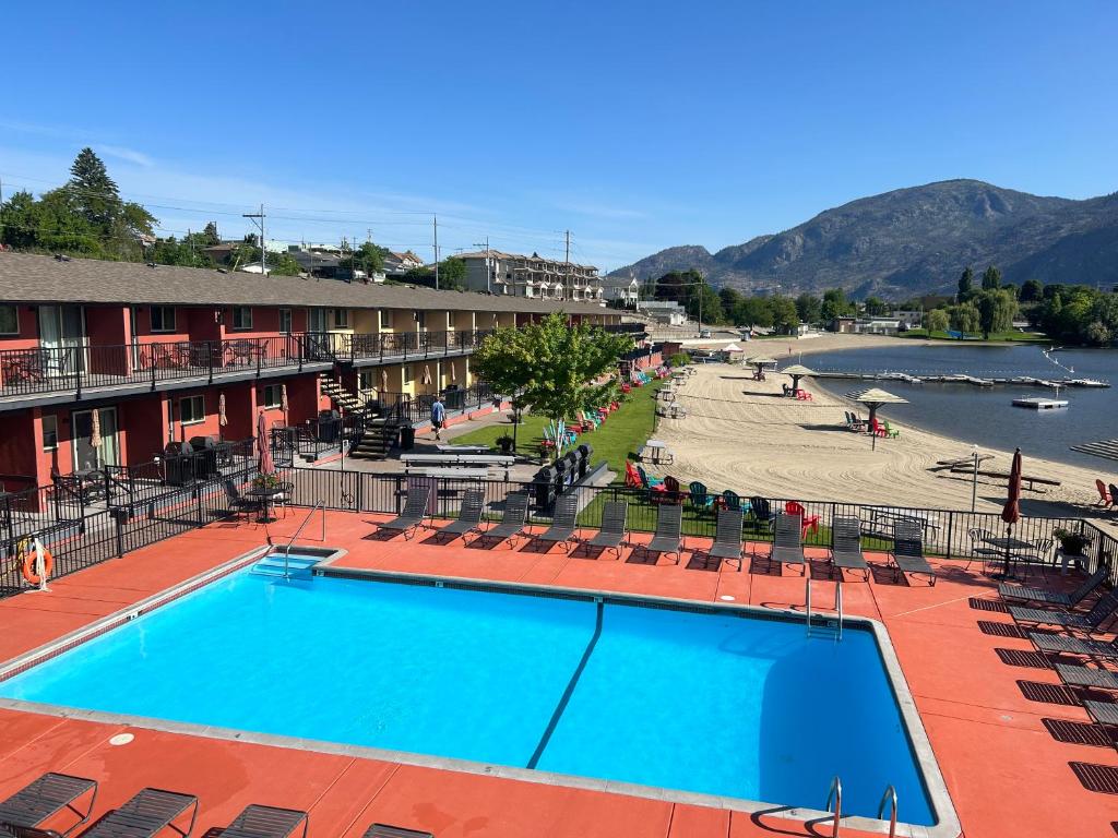a view of a resort with a swimming pool and a beach at Safari Beach Resort in Osoyoos