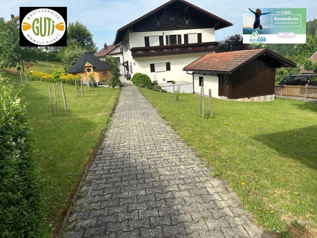 a cobblestone path in front of a house at Haus Monica in Bodenmais
