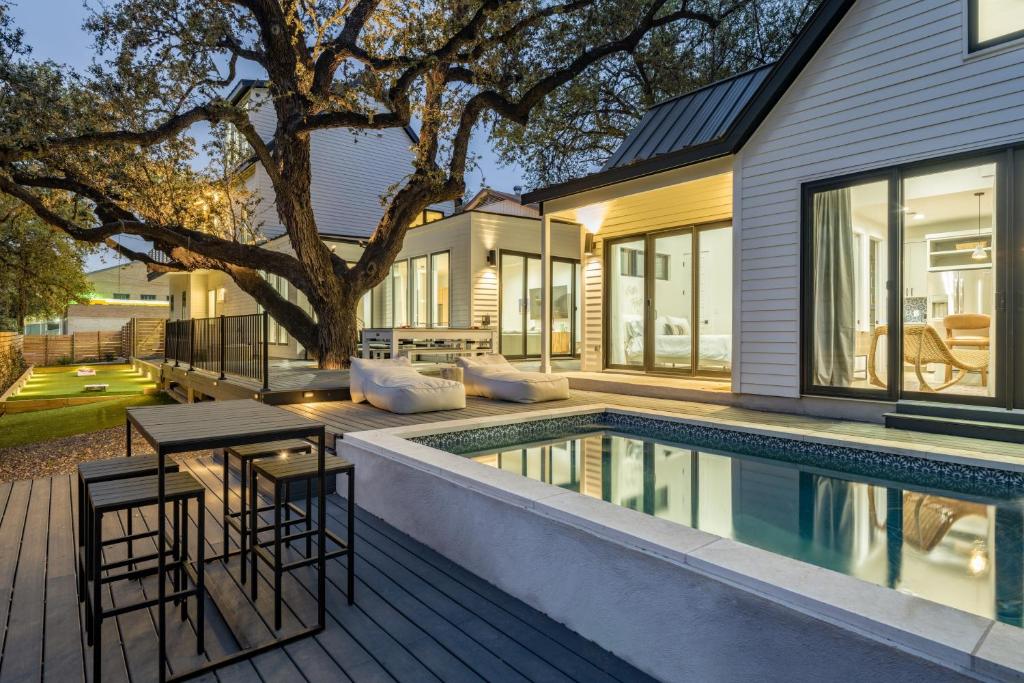 a house with a swimming pool next to a house at Henley by AvantStay Plunge Pool Incredible Patio Guest House in Austin