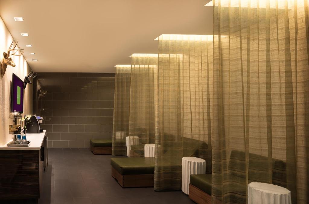 a waiting room with green chairs and curtains at The LINQ Hotel and Casino in Las Vegas