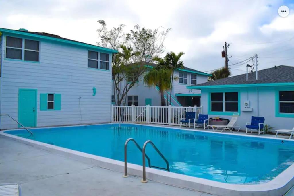 una gran piscina frente a una casa en Private Large Studio 19-Directly Across from Beach en St Pete Beach