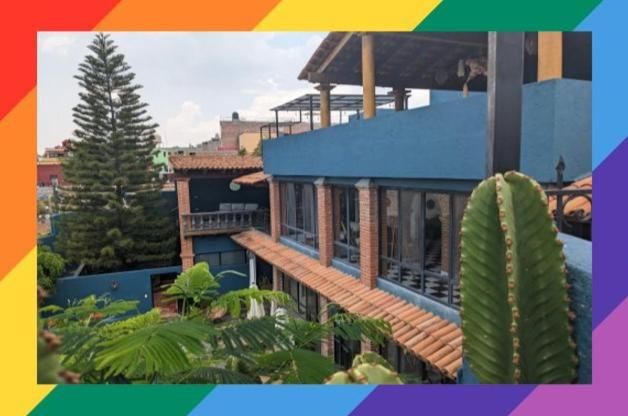 a colorful picture of a house with a cactus at La Joya Azul SMA - LGBTQS in San Miguel de Allende