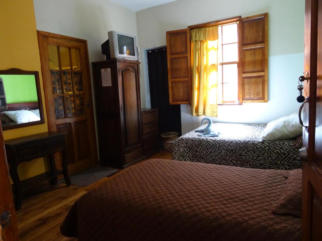Postel nebo postele na pokoji v ubytování Hostal del Piamonte