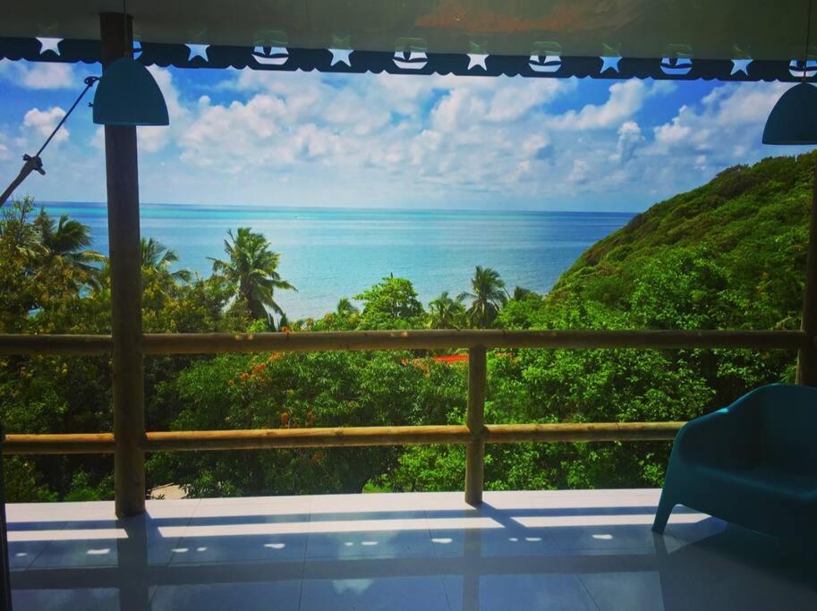 a room with a view of the ocean at La Casita Azul Boutique Villa in Providencia