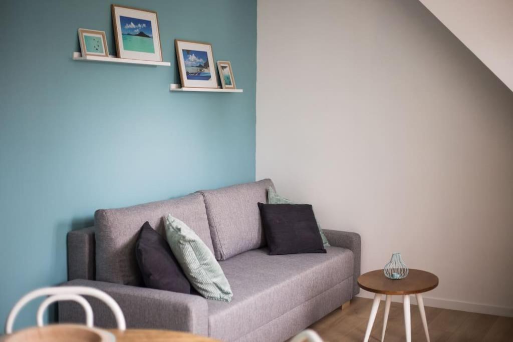 a living room with a couch and a table at Maupiti proche Etretat et Fécamp in Vattetot-sur-Mer