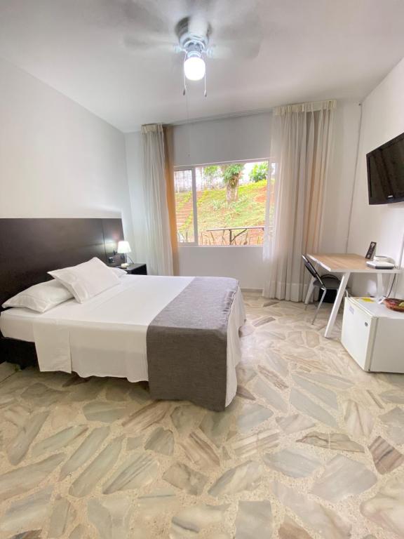 Postel nebo postele na pokoji v ubytování Babilla Suites