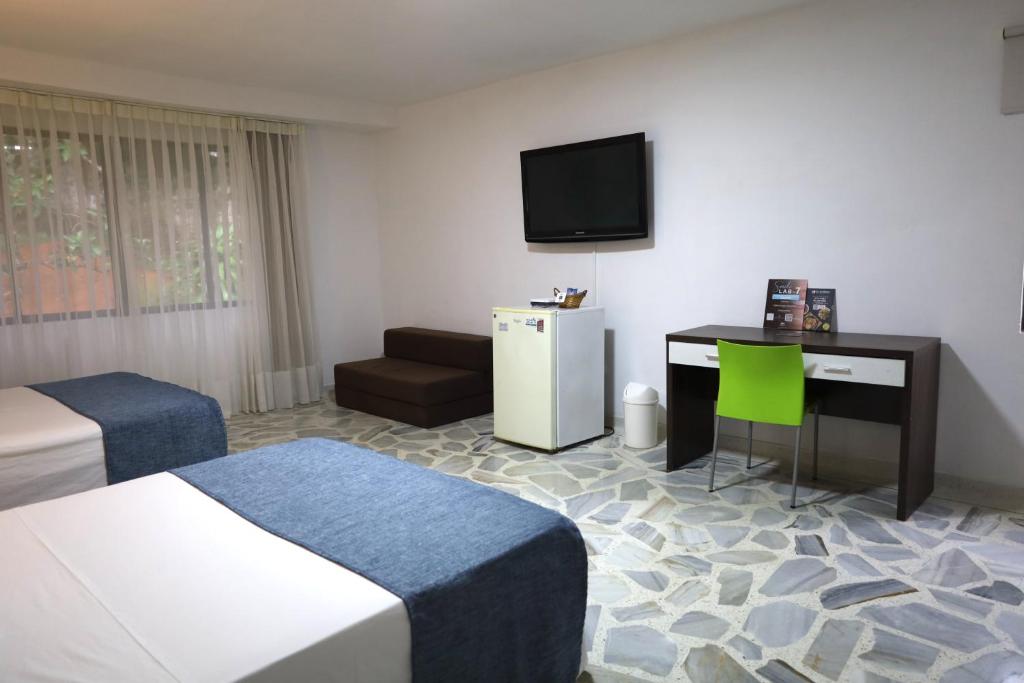 TV a/nebo společenská místnost v ubytování Babilla Suites