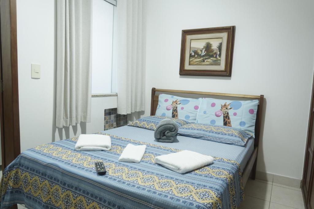 a bedroom with a bed with two pillows on it at CANTO DA ARVORE 1 in Arraial do Cabo