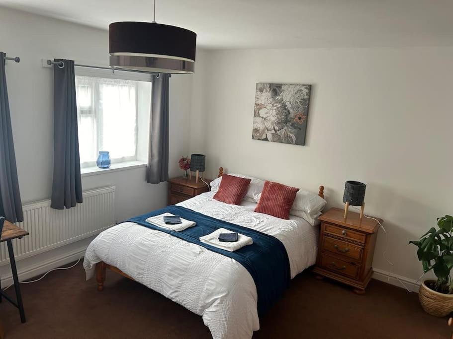 a bedroom with a bed with two plates on it at Airport Retreat in Handforth