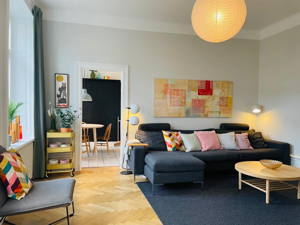 a living room with a couch and a table at Cool and light 2 room apartment in SoFo in Stockholm