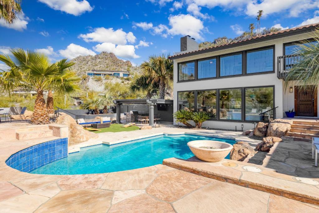 a swimming pool in the backyard of a house at Desert Lagoon by AvantStay Luxury Phoenix Home w Entertainer’s Backyard in Scottsdale