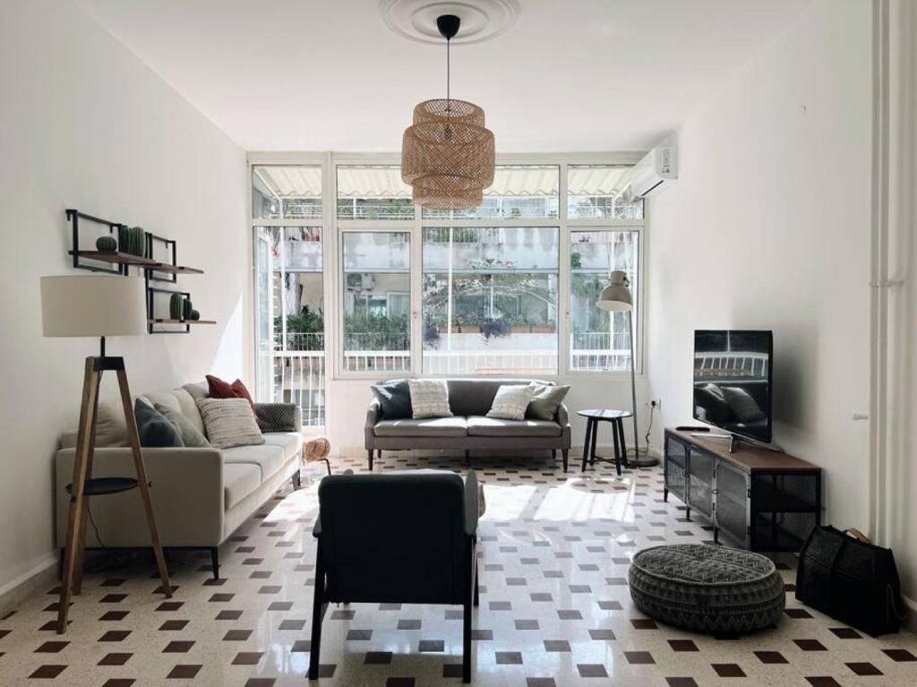 a living room with a couch and a table at Sunny Eclectic 3BR house in Gemmayze in Beirut