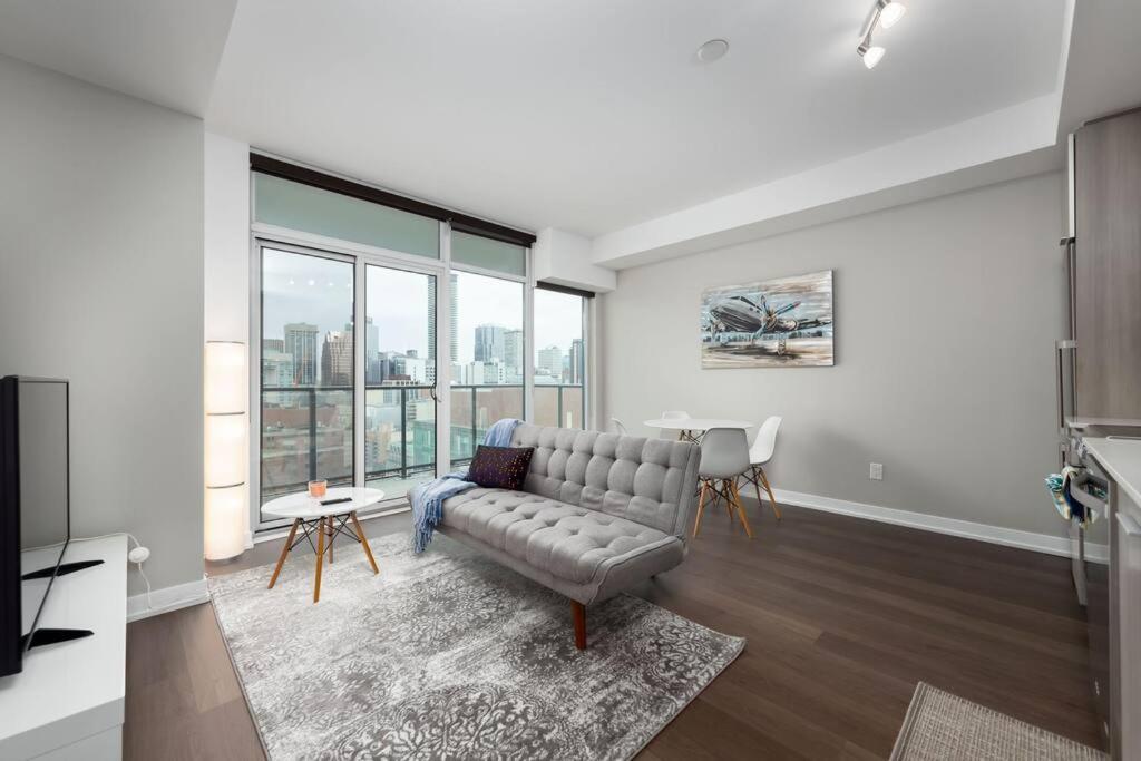 a living room with a couch and a table at Toronto Condo with a View, St. Lawrence Market in Toronto