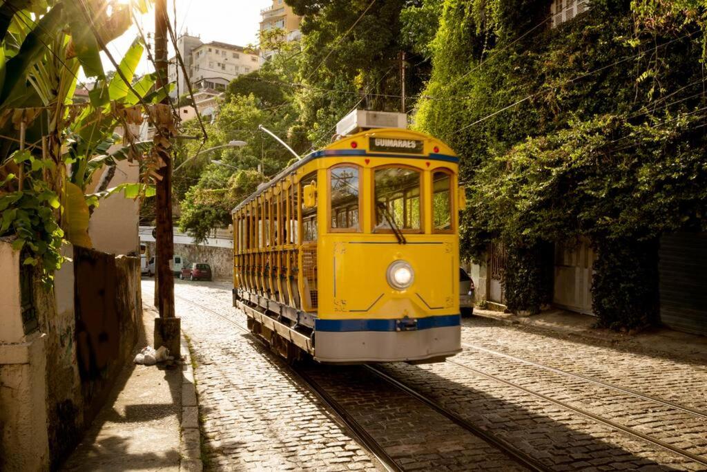 a yellow trolly car on a street at Casa Teresa in Rio de Janeiro