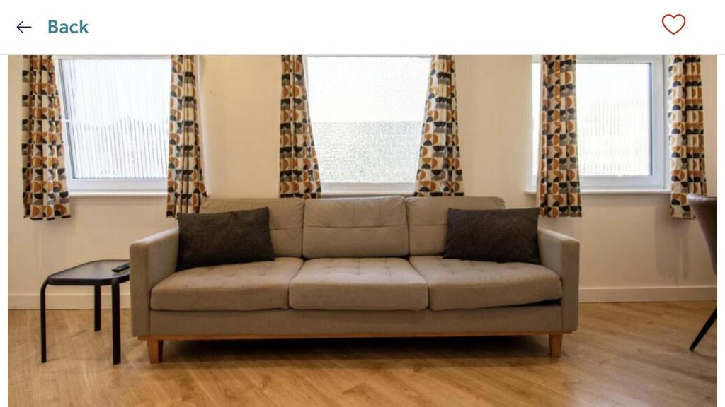 a couch in a living room with a window at Captivating 1-Bed Apartment in Southampton in Southampton