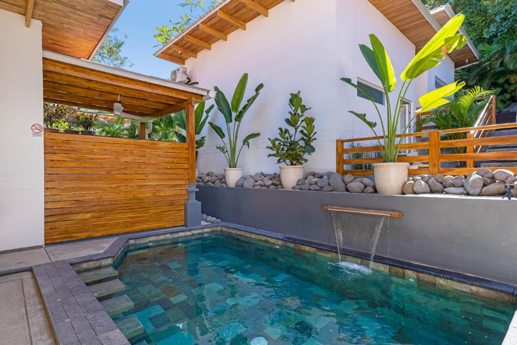 una piscina in un cortile con recinzione in legno di 4 You Hotel Nosara a Playa Guiones