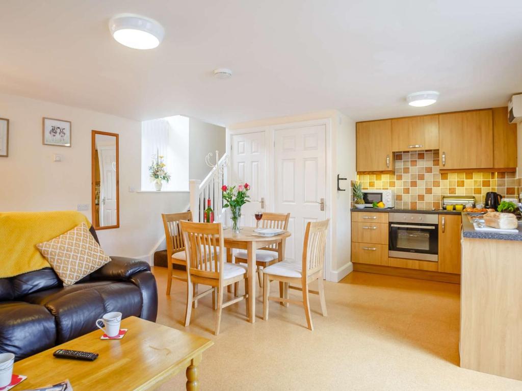 a kitchen and living room with a table and chairs at 1 Bed in Bala 89369 in Llandderfel