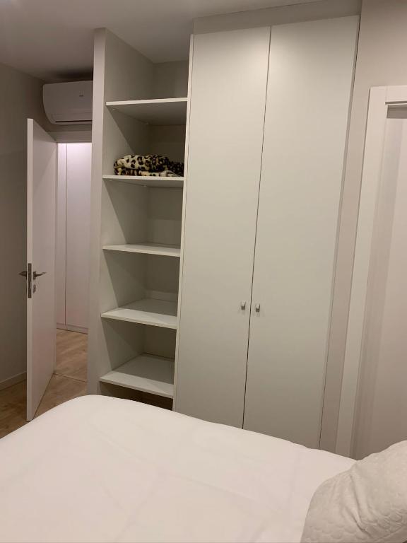 a white bedroom with a bed and white cabinets at Habitación doble con baño privado en Barcelona in Barcelona