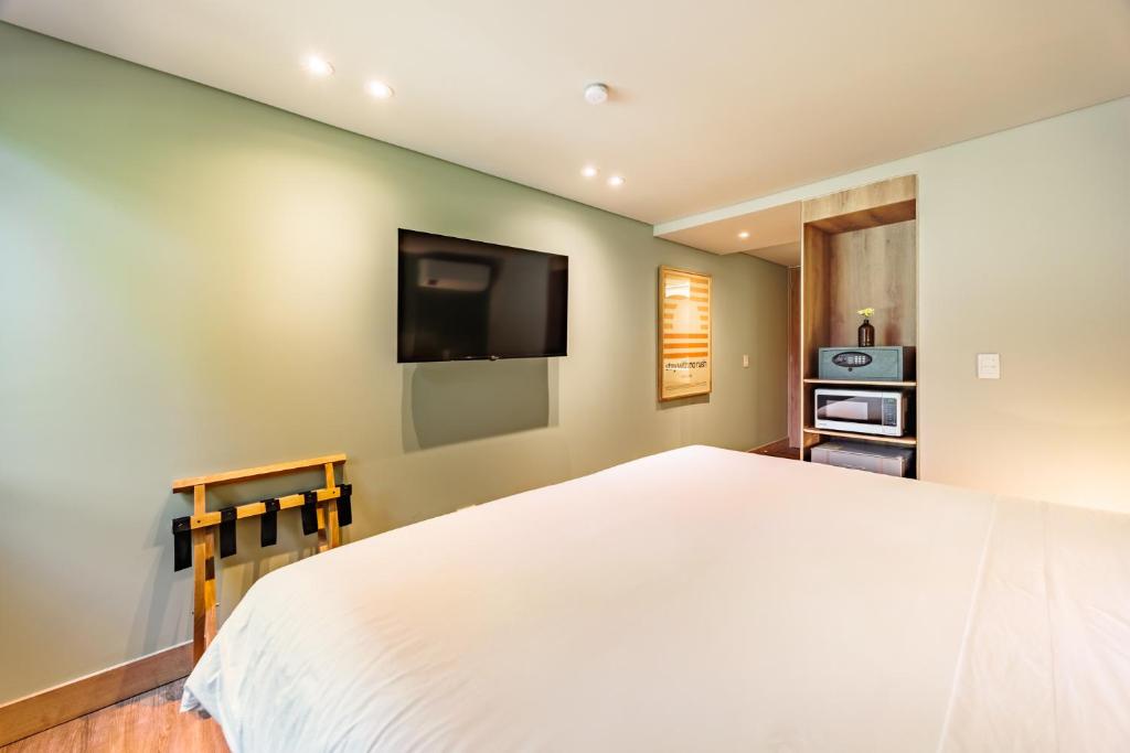 Cama o camas de una habitación en The Somos Central Hotel Poblado