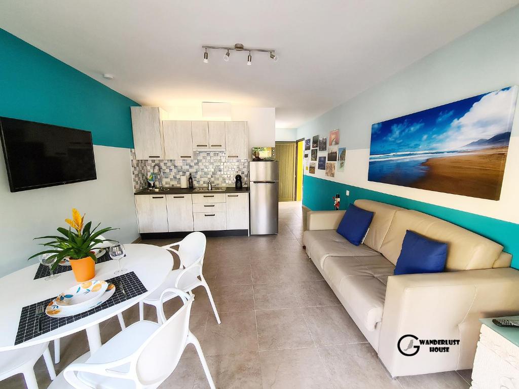 a living room with a couch and a table at Atlantic Garden Wanderlust House in Corralejo
