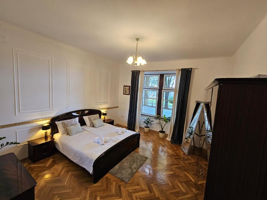 ein Schlafzimmer mit einem Bett und einem großen Fenster in der Unterkunft Villa Münz Apartment Franz in Pula