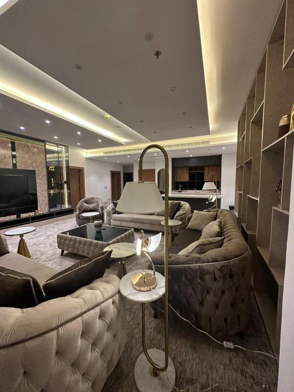 uma sala de estar com dois sofás e uma televisão em شقة فاخرة في برج جلامور em Riyadh