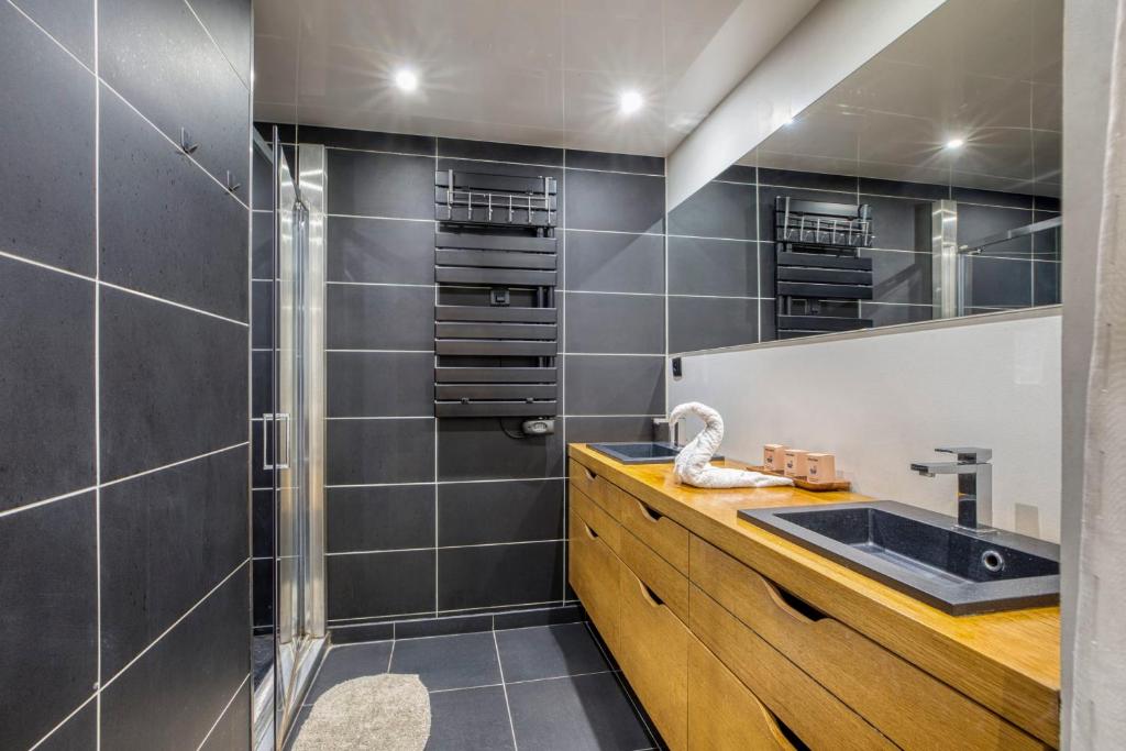 a bathroom with a sink and a shower at Spacious and cosy flat in Annecy