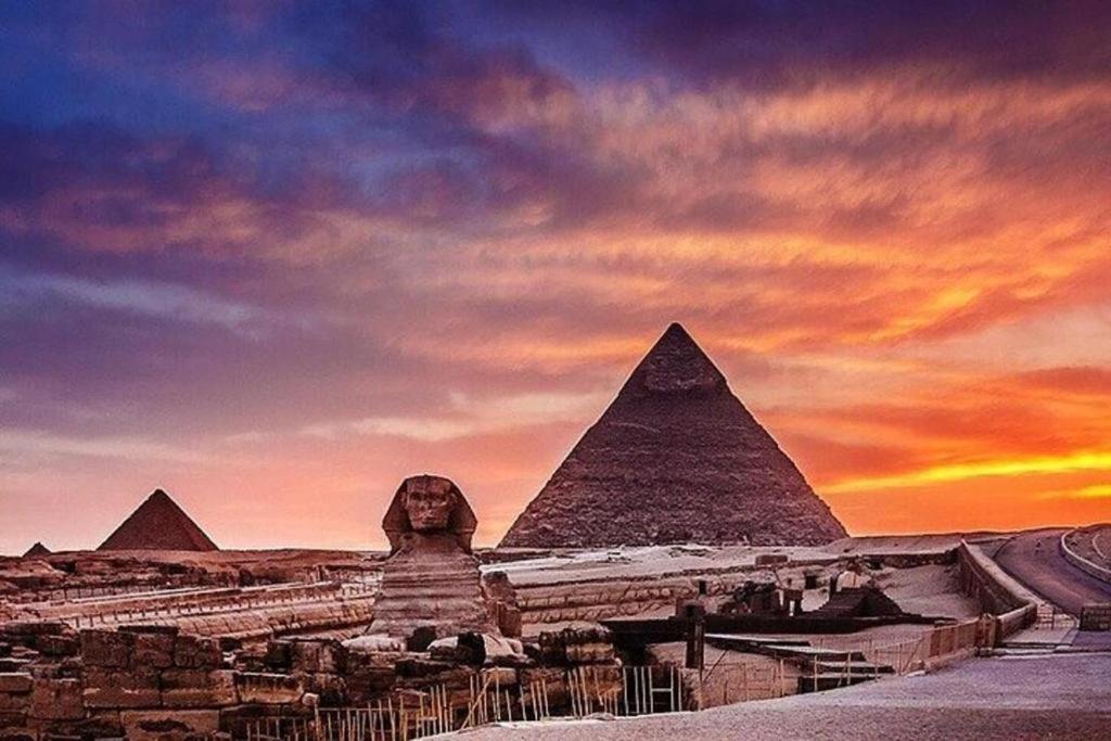 a view of the pyramids of giza at sunset at Pyramids Hotel in Cairo