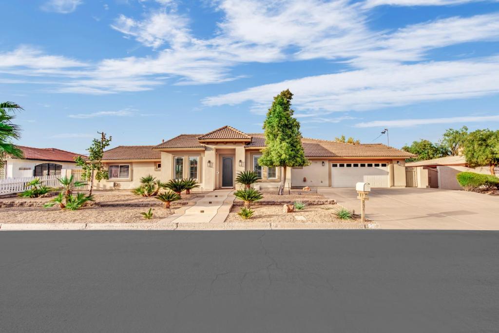 a house with a tree in the front yard at Oasis Retreat at Henderson Greens in Las Vegas