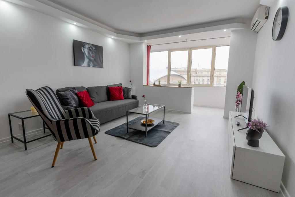 a living room with a couch and a table at Quiet Apartment Ruby Horizon in Bucharest