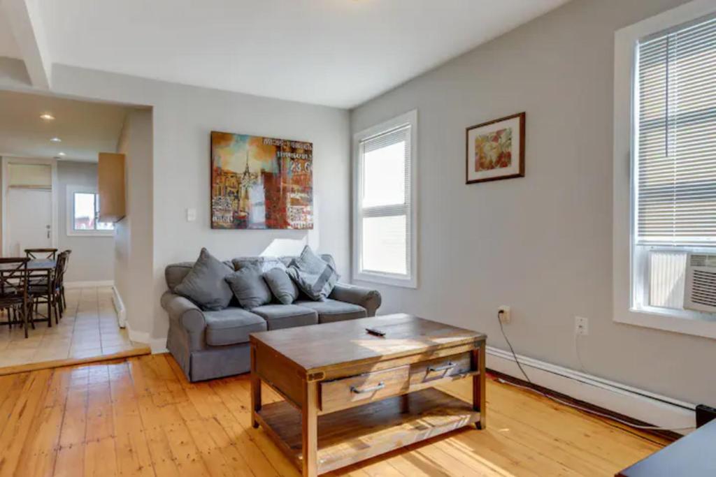a living room with a couch and a table at NEW! Boston Entire House Near MBTA, 3 Mi to Fenway! in Boston