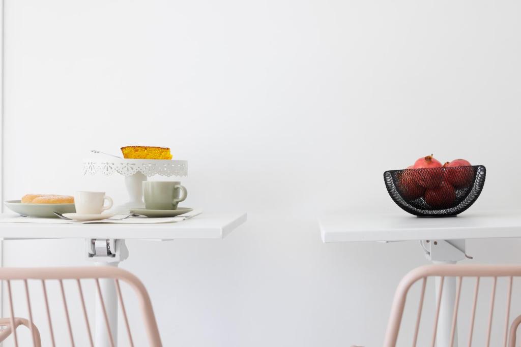 a table with two chairs and a plate of food on it at Essentia Rooms & Relax in Vasto