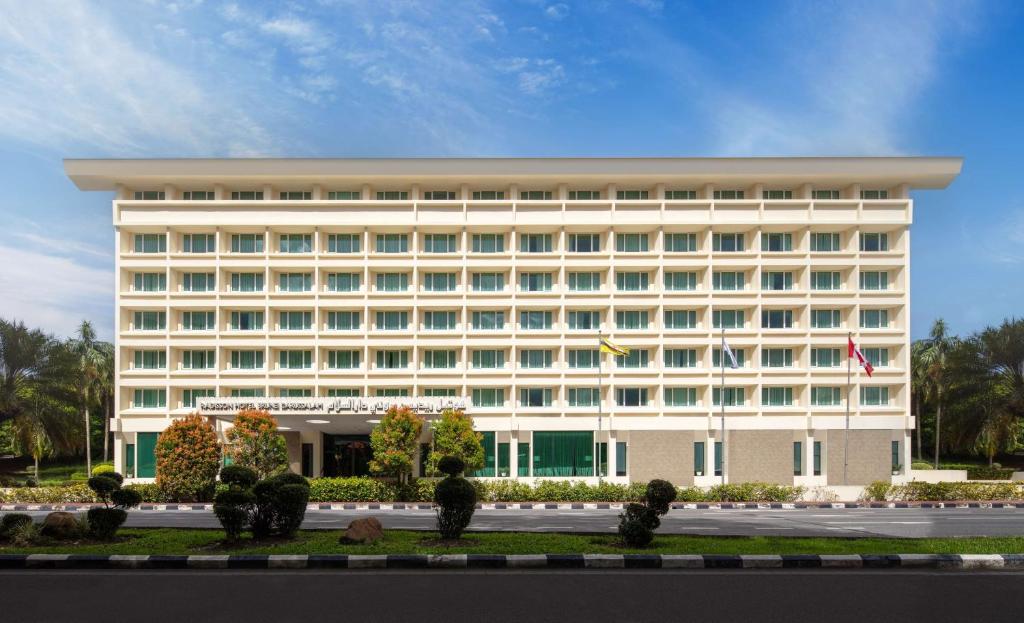a large white building with a lot of windows at Radisson Hotel Brunei Darussalam in Bandar Seri Begawan