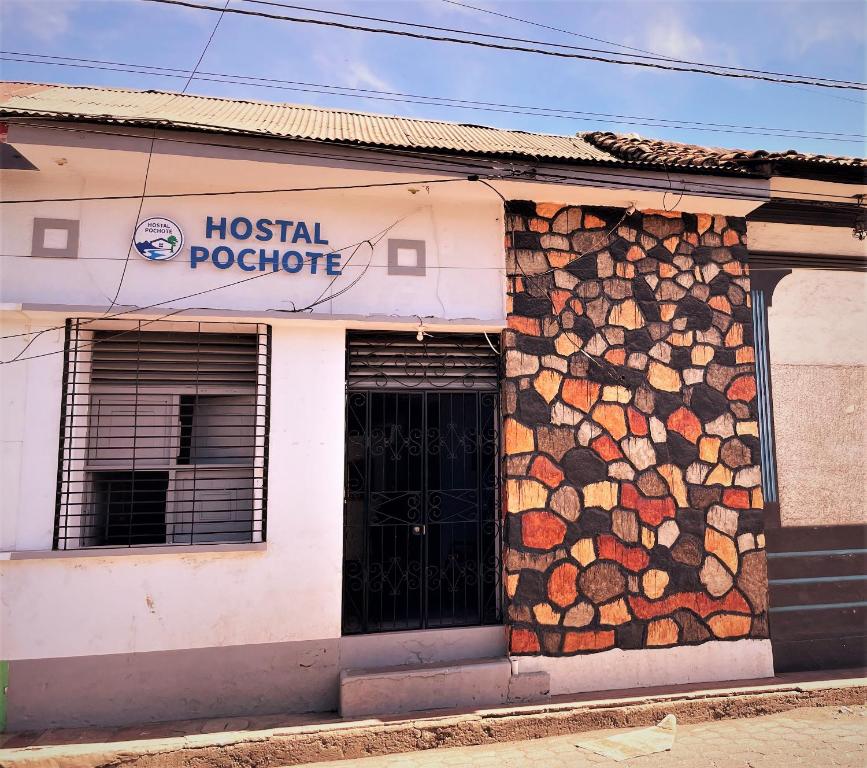 a building with a bunch of logs on the side of it at Hostal Pochote in León