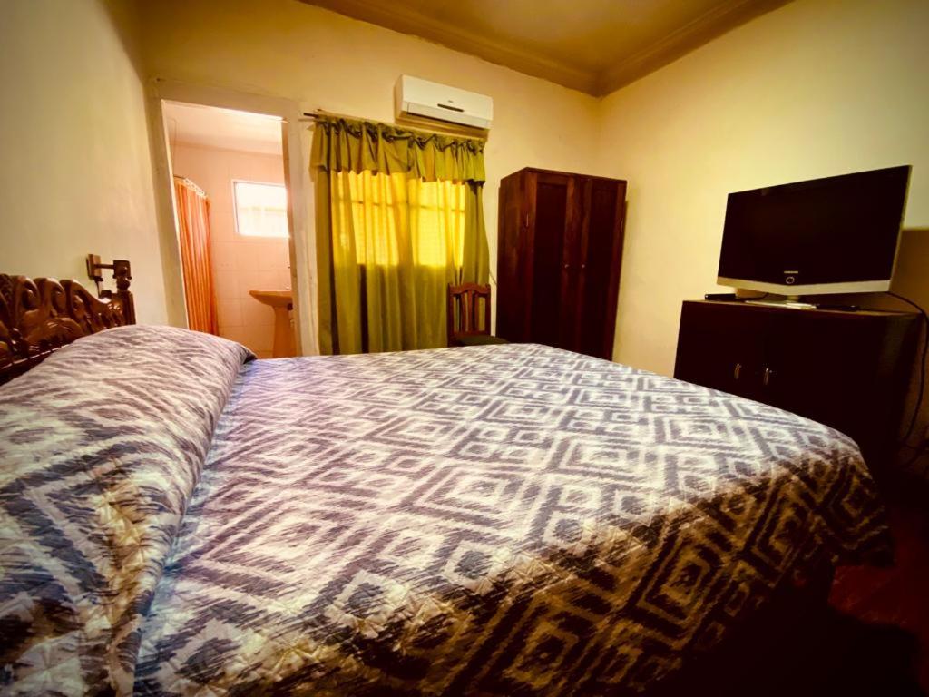 Łóżko lub łóżka w pokoju w obiekcie Residencial Italiana