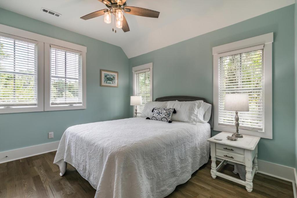 a bedroom with a bed and a ceiling fan at Newly Listed Duke St Cottage - Downtown Beaufort in Beaufort
