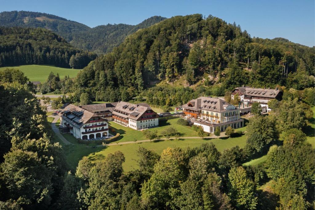 an aerial view of a mansion in the mountains at Arabella Jagdhof Resort am Fuschlsee, a Tribute Portfolio Hotel in Hof bei Salzburg
