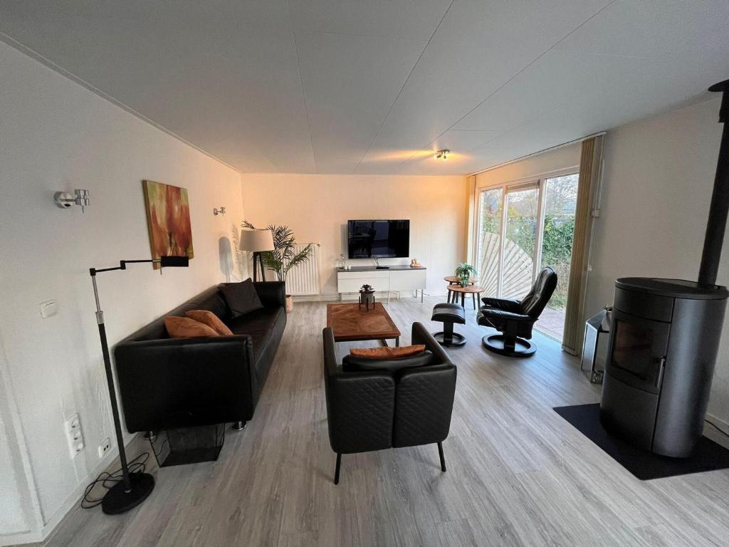 a living room with a couch and a table at Bungalow in Makkum near Lake Beach in Holle Poarte