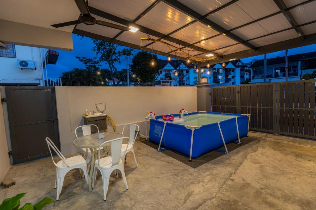 a patio with a ping pong table and chairs at 10Px 5BR V Jaccuzi Spa n KTV n Kids Pool n Pool Table Near USM n Lam Wah Ee Hospital in Gelugor